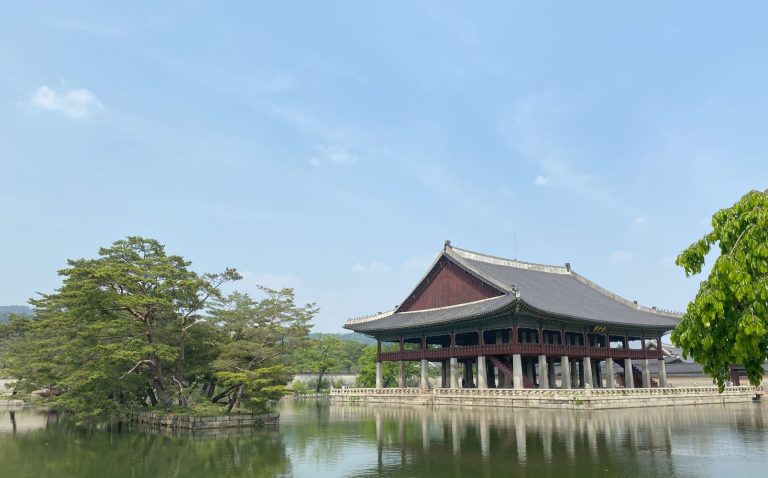 A historical building sits at the edge of a lake in Seoul, South Korea.