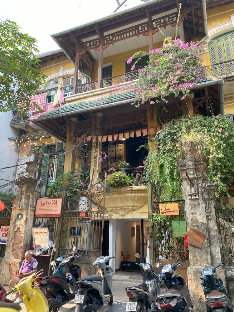 A French style building with plants growing along the windows in Hanoi, Vietnam.