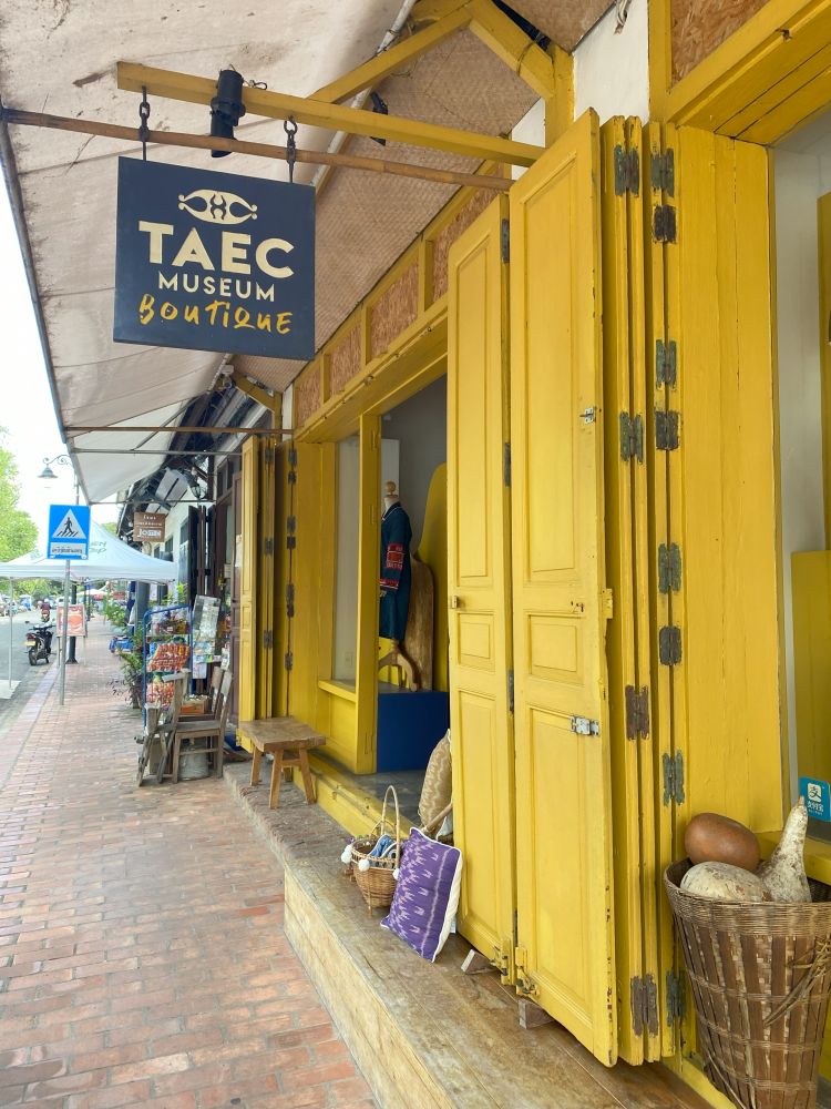 A shopfront with bright yellow paneling.