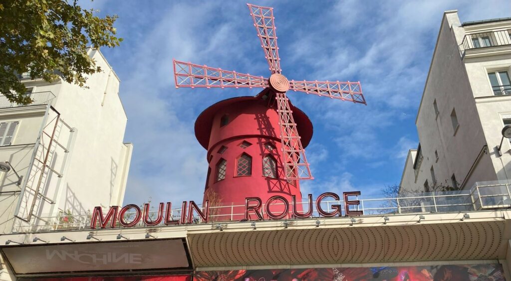 The iconic red windmill of the Moulin Rouge cabaret in Montmartre.