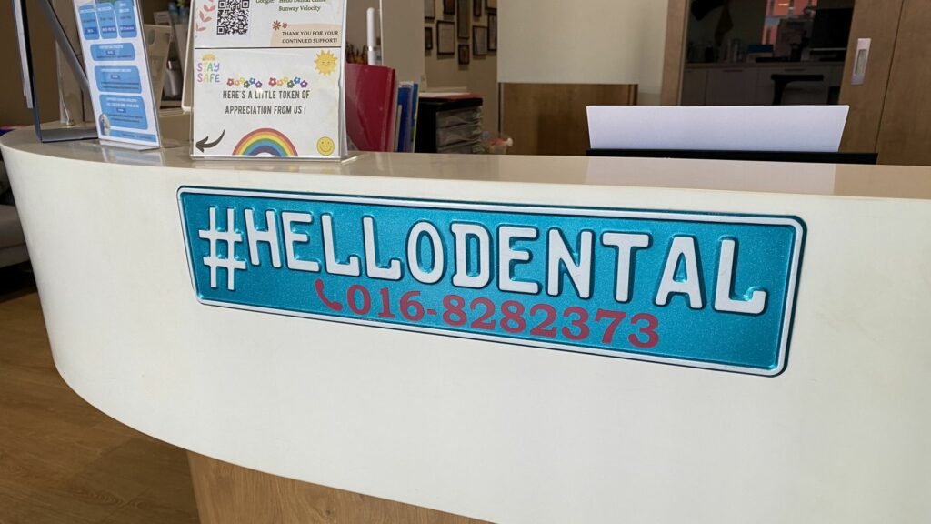 Hello Dental desk with phone number plate