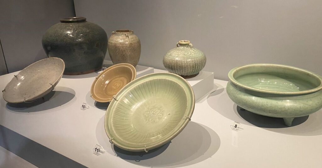 A selection of bowls, pots and plates with basic designs and light color washes.