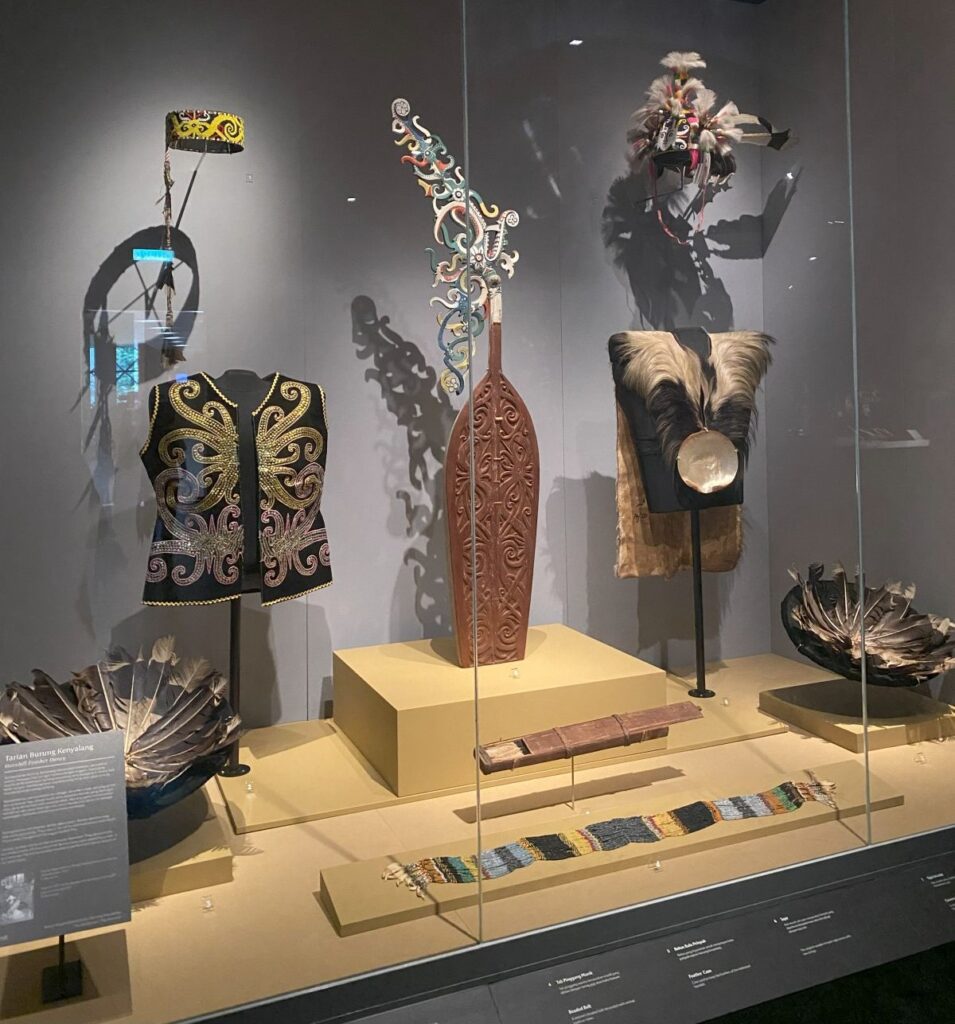 Two traditional Borneo tribal outfits including a feathered headdress.