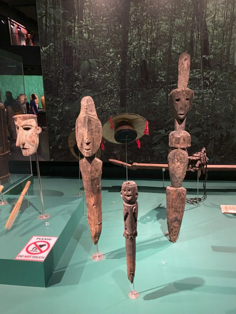 Small wooden figures, carved into spike shapes.