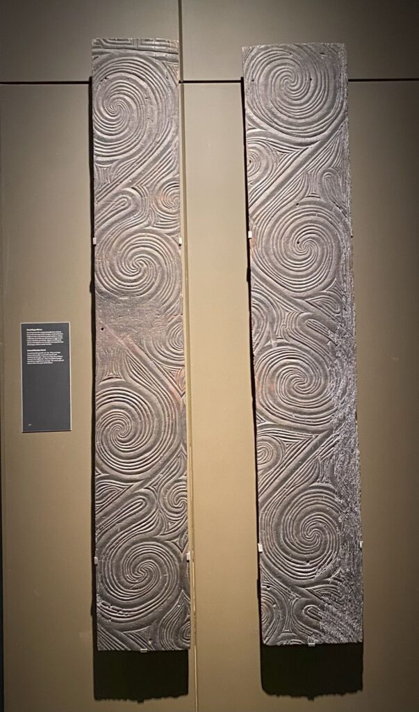 Large wooden panels with carved swirl designs.