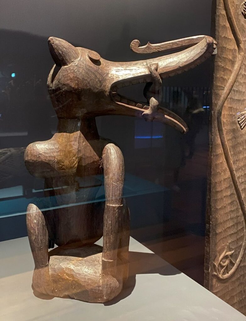 A carved wooden figure of an unknown animal (it kinda looks like a dog).