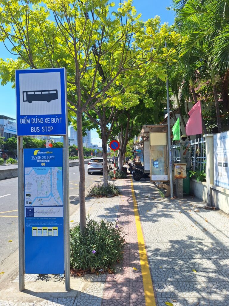 A bus stop in Da Nang showing the local public bus service, with a sheltered seating area.